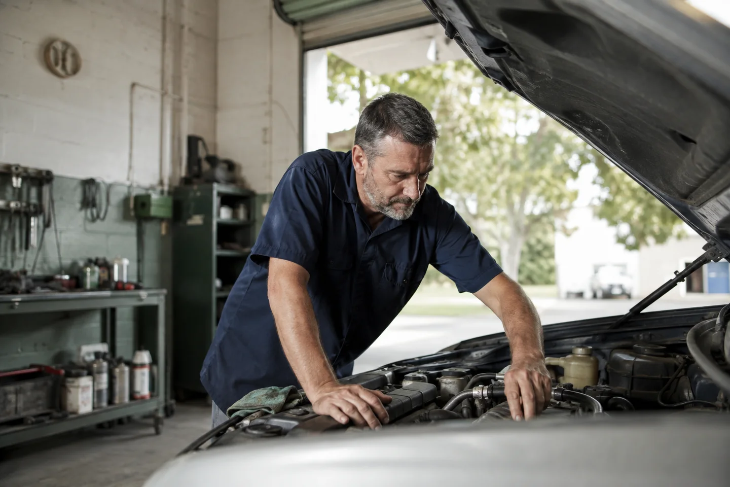 A mechanic working on a car in an independent repair shop